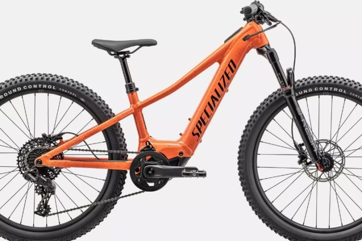 Orange mountain bike with thick tires and black lettering on a white background.