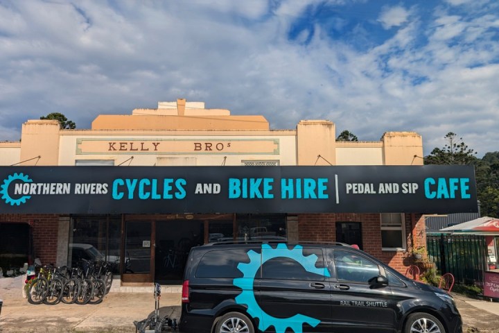 Storefront with bikes for rent, a van parked in front, and Northern Rivers Cycles sign.