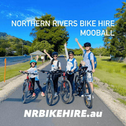 Four people with bikes on a sunny pathway, wearing helmets, with text 'Northern Rivers Bike Hire Mooball'.